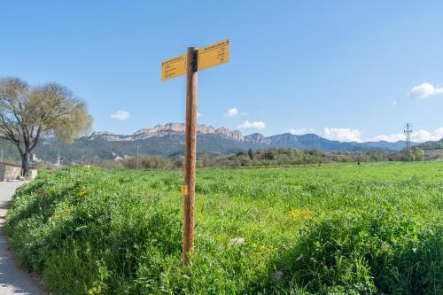 a street sign in the middle of a field at Ca l'Agnès in Oliana
