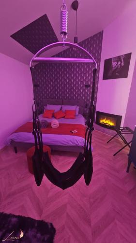 a bedroom with a swing bed with a fireplace at L'écrin in Orbec-en-Auge
