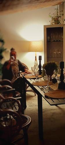 a man sitting at a table with wine glasses on it at Voda Suite in Bergama