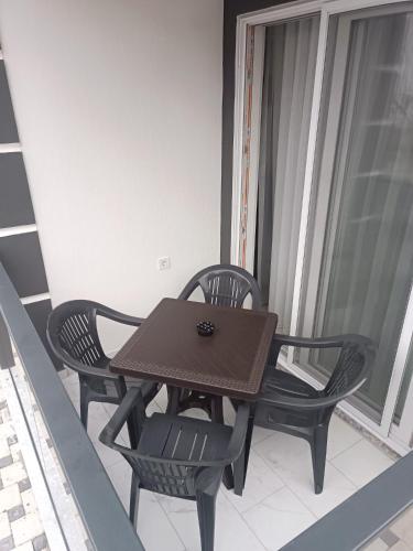 a brown table and chairs on a balcony at YoYo Apart in Dalaman