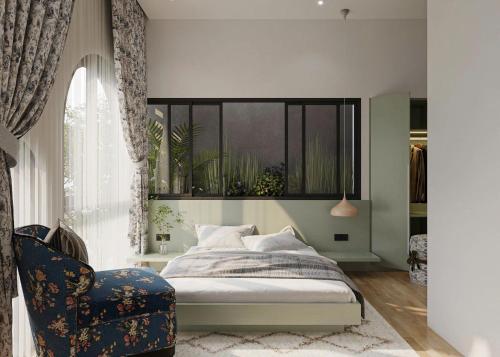 a bedroom with a bed and a chair and a window at Jen's Home in Danang