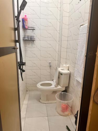 a bathroom with a white toilet in a room at Soul naz homes in Dar es Salaam