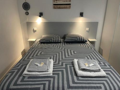 a bedroom with a bed with towels on it at Baie de Sanary - Beau F2 bord de mer avec piscine in Six-Fours-les-Plages
