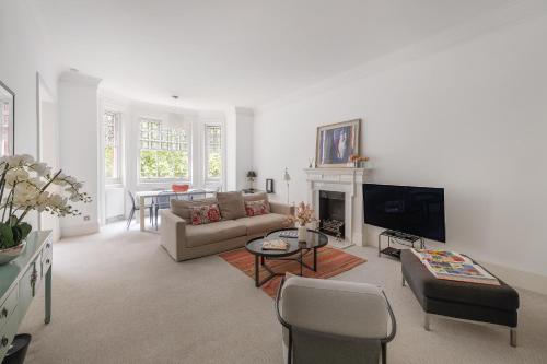 a living room with a couch and a fireplace at Casa Italia near Sloane Square, Harrods and Kings Road - Washing Machine & Wifi in London