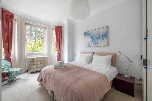 a bedroom with a large bed and a chair at Casa Italia near Sloane Square, Harrods and Kings Road - Washing Machine & Wifi in London