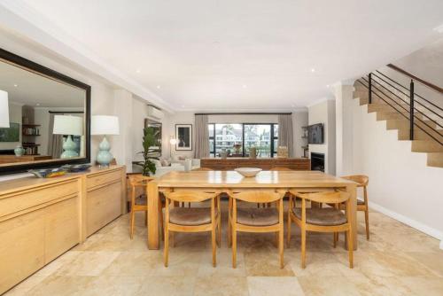 a kitchen and dining room with a wooden table and chairs at Luxury Lodge 4C, Pearl Valley Golf Course in Paarl