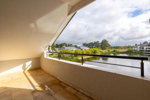 a balcony with a view of a river at Luxury Lodge 4C, Pearl Valley Golf Course in Paarl