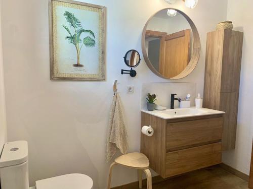 a bathroom with a sink and a mirror at VILLA ERIC with a private stunning heated pool in Puerto del Carmen