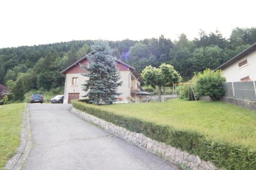 a house with a tree on the side of a driveway at appartement au porte du Trièves in Monestier-de-Clermont