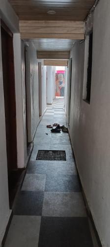 a hallway of an empty building with ailed floor at The Rainbow Residency guest house in Varanasi