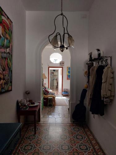 a living room with a hallway with a chandelier at Kanina in Mellieħa
