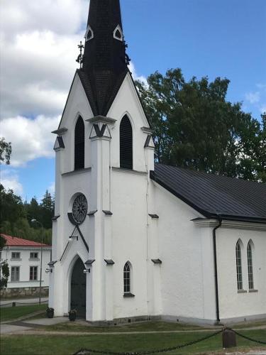 a large white church with a clock on it at Villa Blueberry in Överum