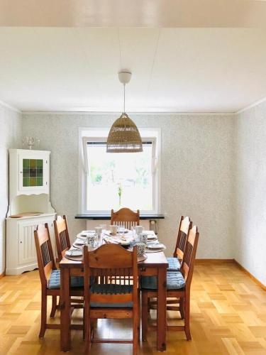 a dining room with a wooden table and chairs at Villa Blueberry in Överum