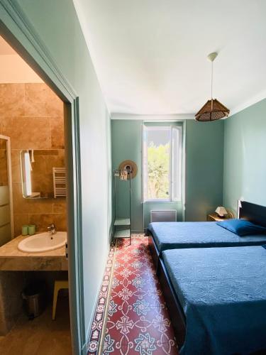une chambre avec un lit et une salle de bain avec un lavabo dans l'établissement Soleil d'Or - Appartement curistes balcon - terrasse, à Lamalou-les-Bains