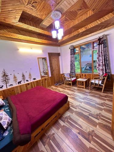 a bedroom with a large bed and a wooden ceiling at Alpine Stays Riverside in Jibhi