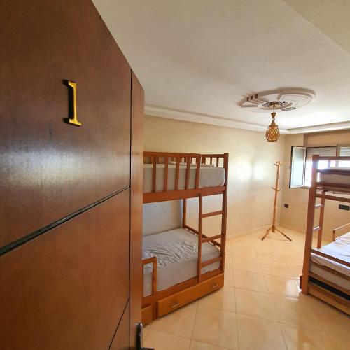 a room with two bunk beds and a refrigerator at The View in Taghazout