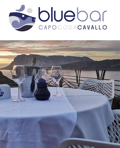 a table with a white table cloth and wine glasses at Punta Est bellissimo 3 camere vista mare in Capo Coda Cavallo
