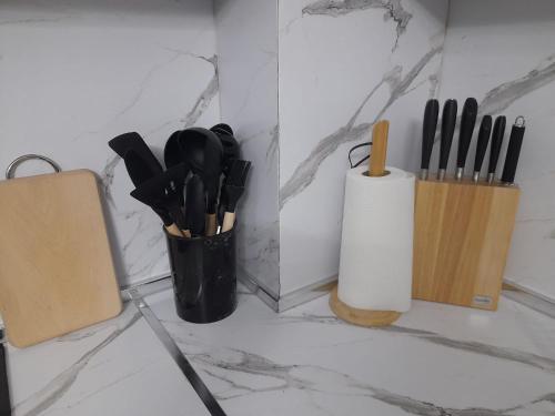 a counter with some knives and a knife block at Azure Sands Golem in Golem