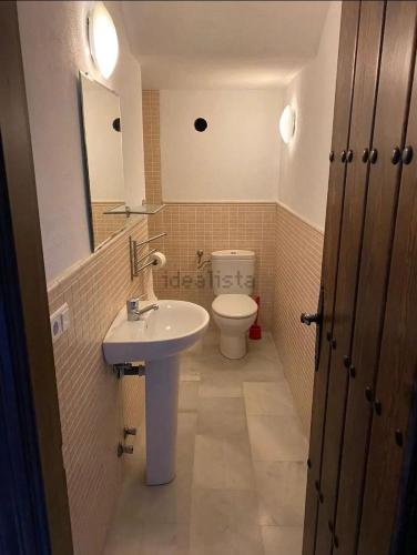 a bathroom with a sink and a toilet at La Casita de Ventorros in Loja