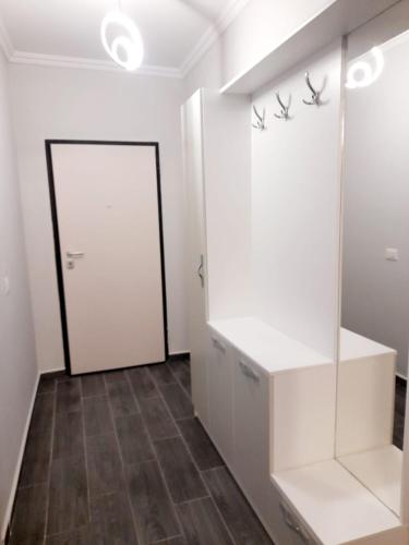 a room with a white closet and a door at Azure Sands Golem in Golem