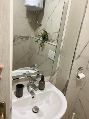 a bathroom with a sink and a mirror at Azure Sands Golem in Golem