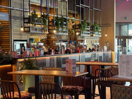 a restaurant with tables and chairs and a bar at Haven allhallows in Allhallows