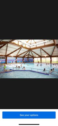 a large swimming pool with people in the water at Haven allhallows in Allhallows