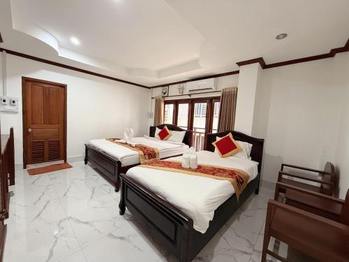 a bedroom with two beds in a room at Vangvieng Sisavang Hotel in Vang Vieng