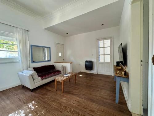 a living room with a couch and a table at Lo de Nina in Azul