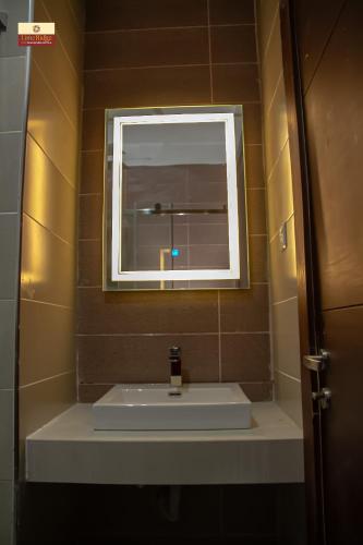 a bathroom with a sink and a window at Limeridge Signature Hotel in Ikeja