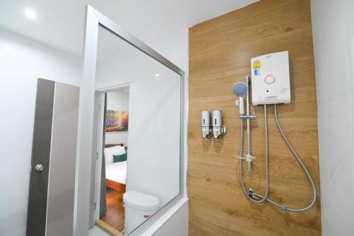 a bathroom with a shower and a mirror at Mina Resort and Spa in Loei