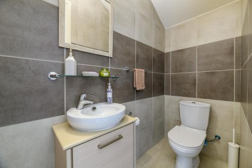 a bathroom with a toilet and a sink at Protaras Holiday Villa - Katia 8B in Protaras