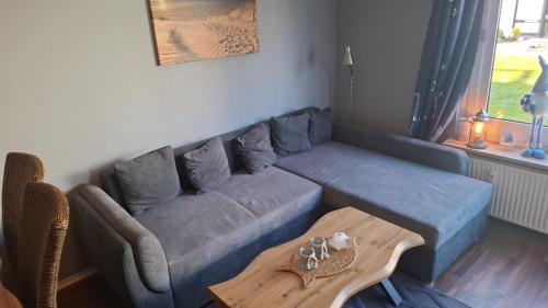 a living room with a couch and a table at Glücksburg Strandnah an der Förde 25 in Glücksburg