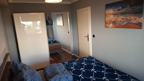 a room with a bedroom with a bed and a mirror at Glücksburg Strandnah an der Förde 25 in Glücksburg