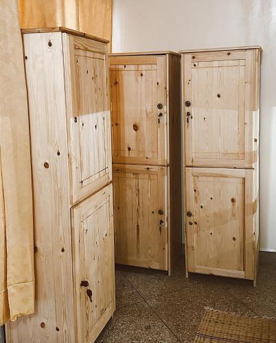 two wooden storage cabinets sitting next to a wall at TAMOUNT Surf House in Agadir