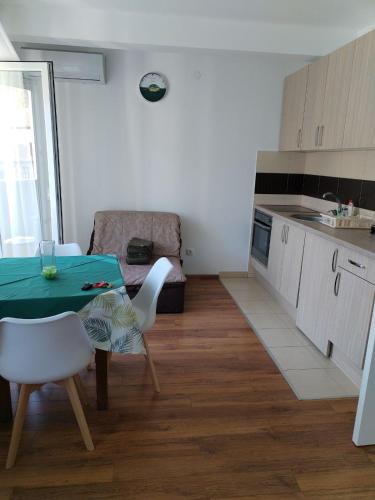 a kitchen with a table and chairs in a room at Apartman WENXIN in Banja Koviljača
