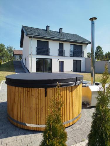 a house with a large barrel in front of it at GaLu- Trelkowko 1 in Kobyłocha