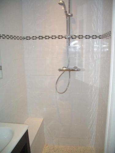a shower with a shower head in a bathroom at Appartement 3 Studios centre ville Saint Tropez avec parking in Saint-Tropez