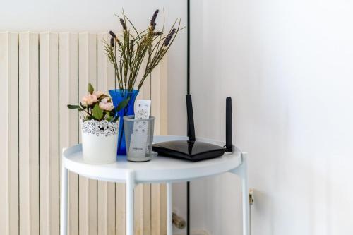 a white table with a laptop and flowers on it at Approdo in Chiavari