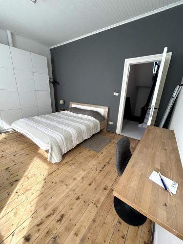 a bedroom with a bed and a wooden table at Spacious townhouse in Antwerp in Antwerp