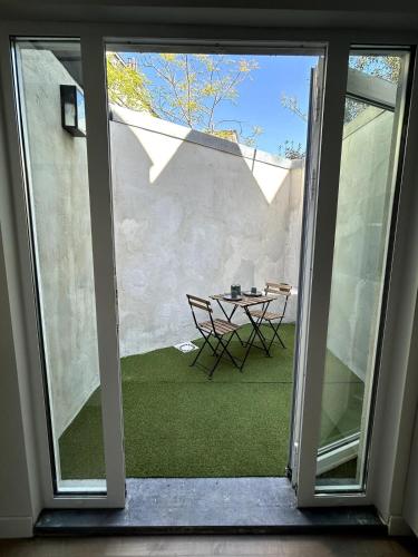 a glass door leading to a patio with a table at Spacious townhouse in Antwerp in Antwerp