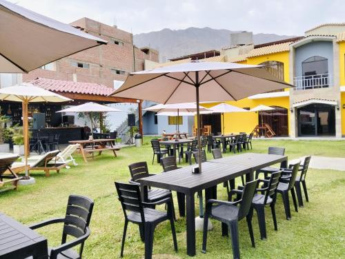 a group of tables and chairs with umbrellas at Tambo II Hotel Campestre in Cieneguilla