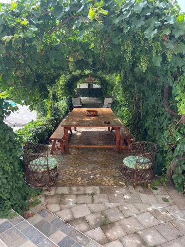 a wooden table and two chairs under a tree at Villa Santa Venera in Marsala