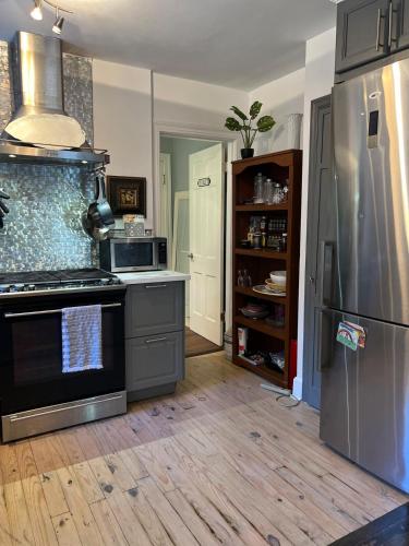 a kitchen with a stove and a refrigerator at cozy retreat in upscale Green Hills in west Nashville in Nashville