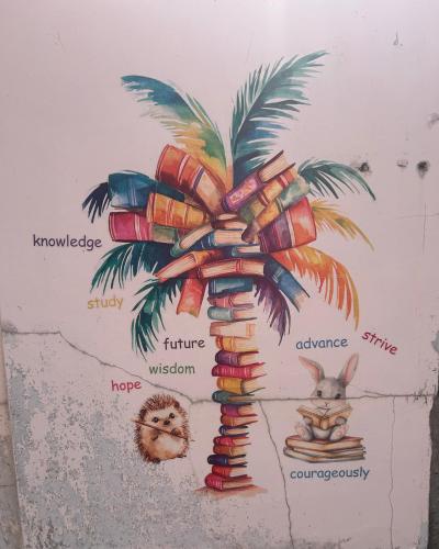 a drawing of a palm tree with a rabbit and books at Airportside Chillhouse in Toyonaka
