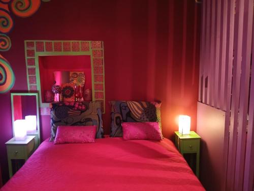 a pink bedroom with a bed with pink sheets at Suite d'Artista Calcata in Calcata