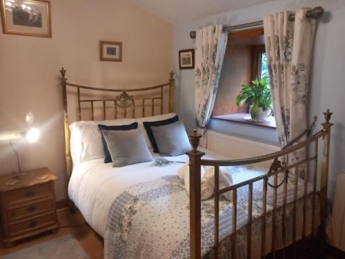 a bedroom with a bed and a window at Walls Clough in Rossendale