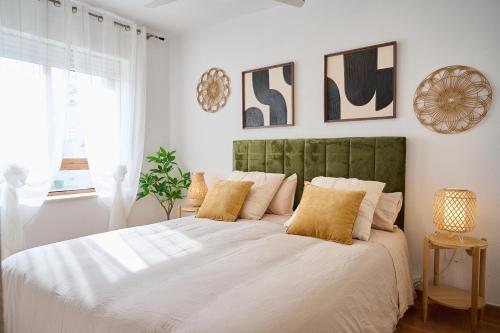 a bedroom with a large white bed with yellow pillows at Font Roja in Albir