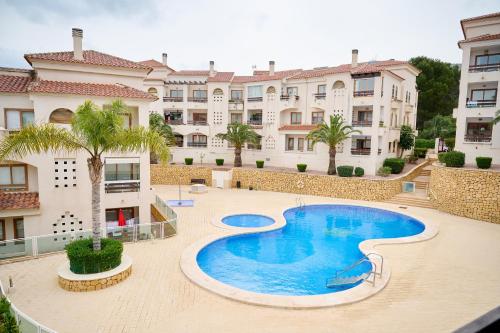a swimming pool in the middle of a building at Font Roja in Albir