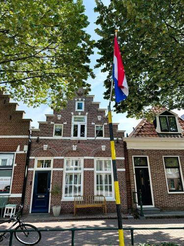 a flag on a pole in front of a building at Beautiful entire house in the center in Medemblik